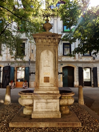A lovely old fountain with some doors. Škofja Loka.